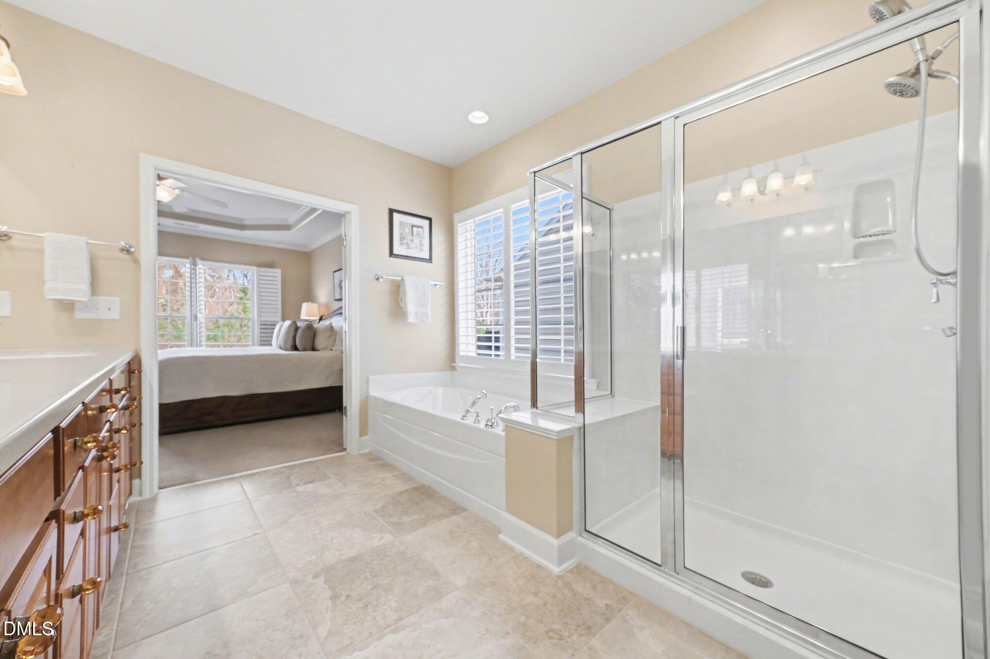 281 Beckingham Loop Cary, NC 27519 - Photo 22 of 56 a spacious bedroom with a balcony a bed and a glass door shower