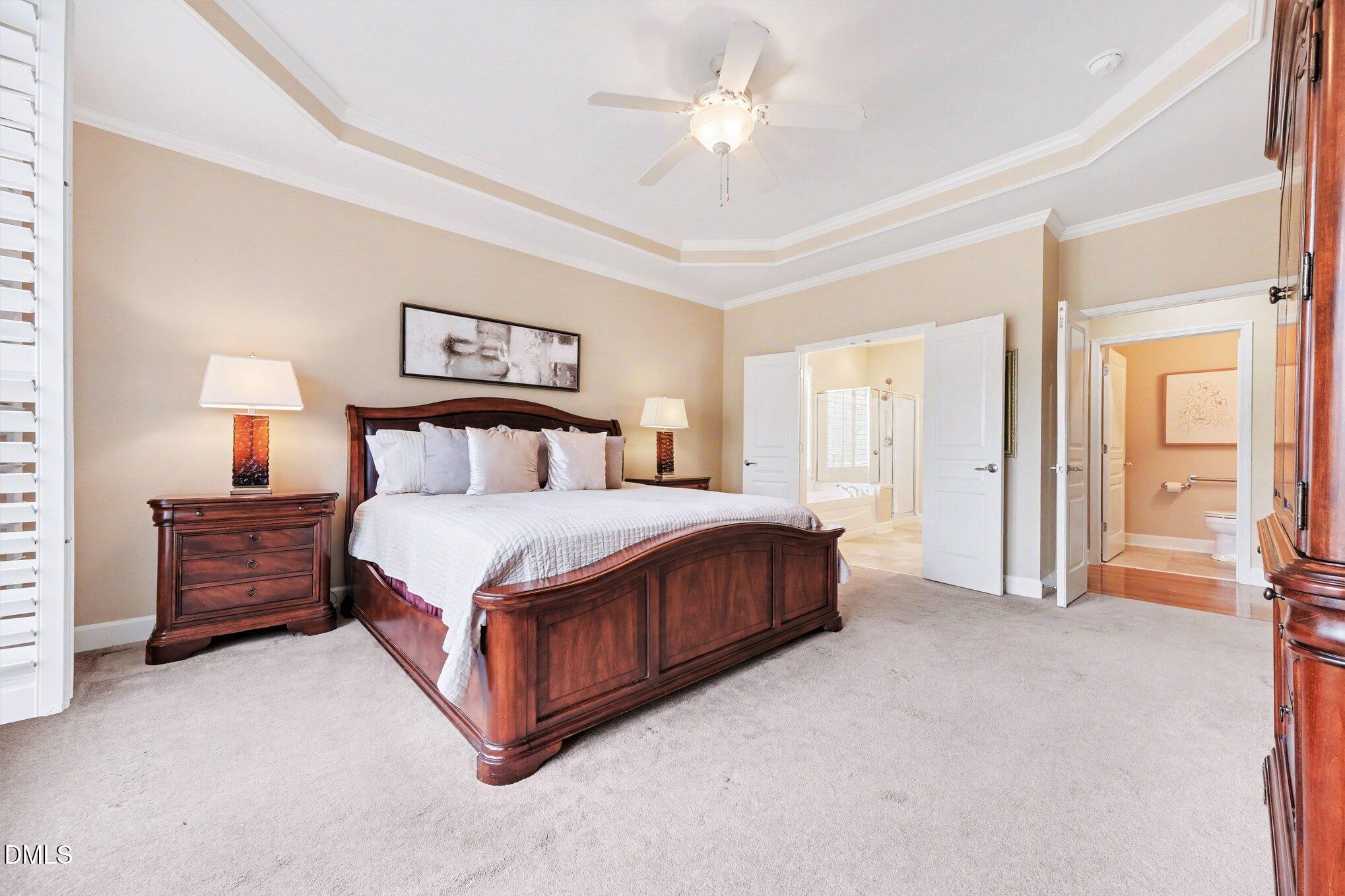 281 Beckingham Loop Cary, NC 27519 - Photo 23 of 56 a spacious bedroom with a bed and a chandelier