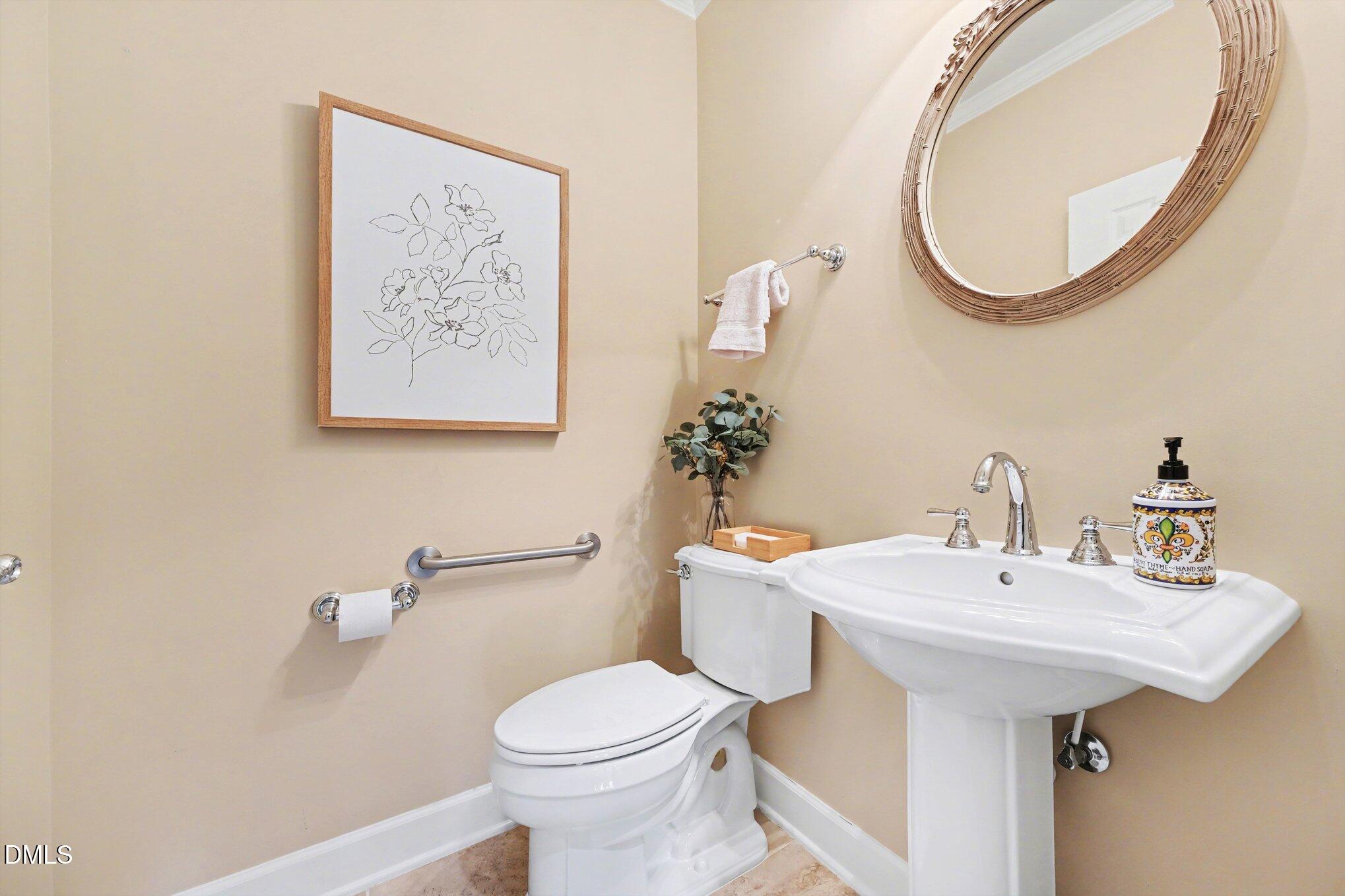 281 Beckingham Loop Cary, NC 27519 - Photo 24 of 56 a bathroom with a sink and a mirror