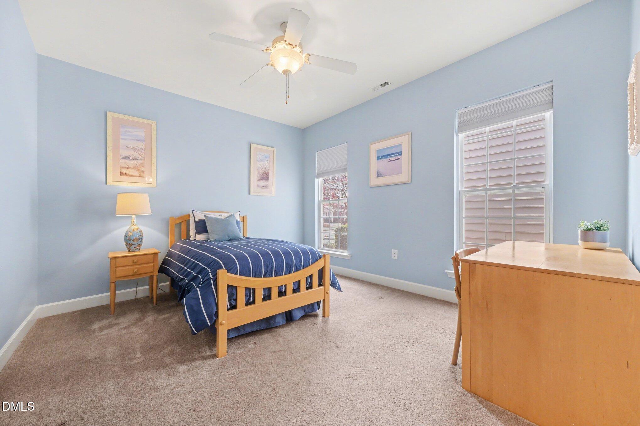 281 Beckingham Loop Cary, NC 27519 - Photo 25 of 56 a room with a bed and a chandelier
