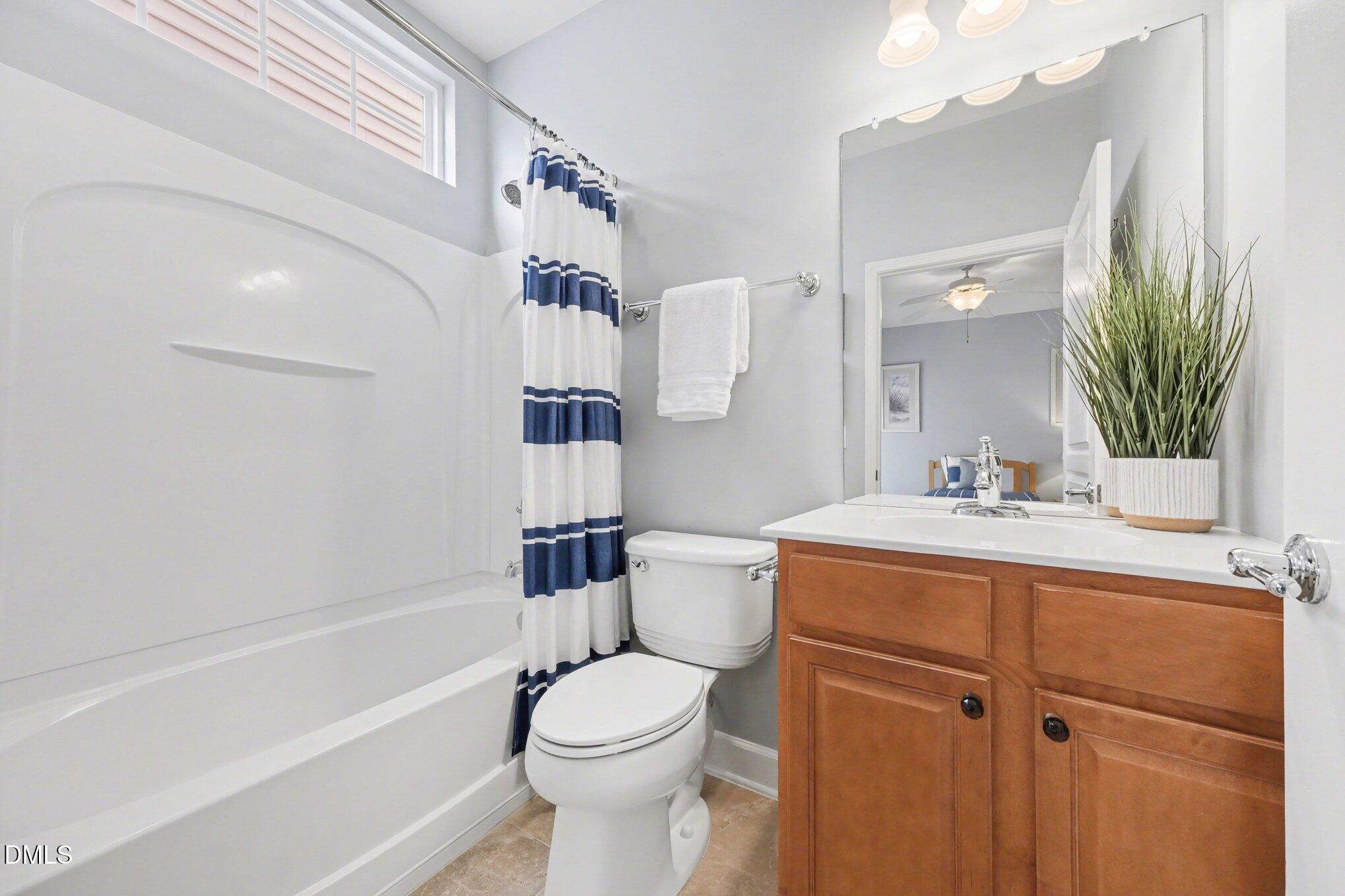 281 Beckingham Loop Cary, NC 27519 - Photo 26 of 56 a bathroom with a sink a toilet and shower