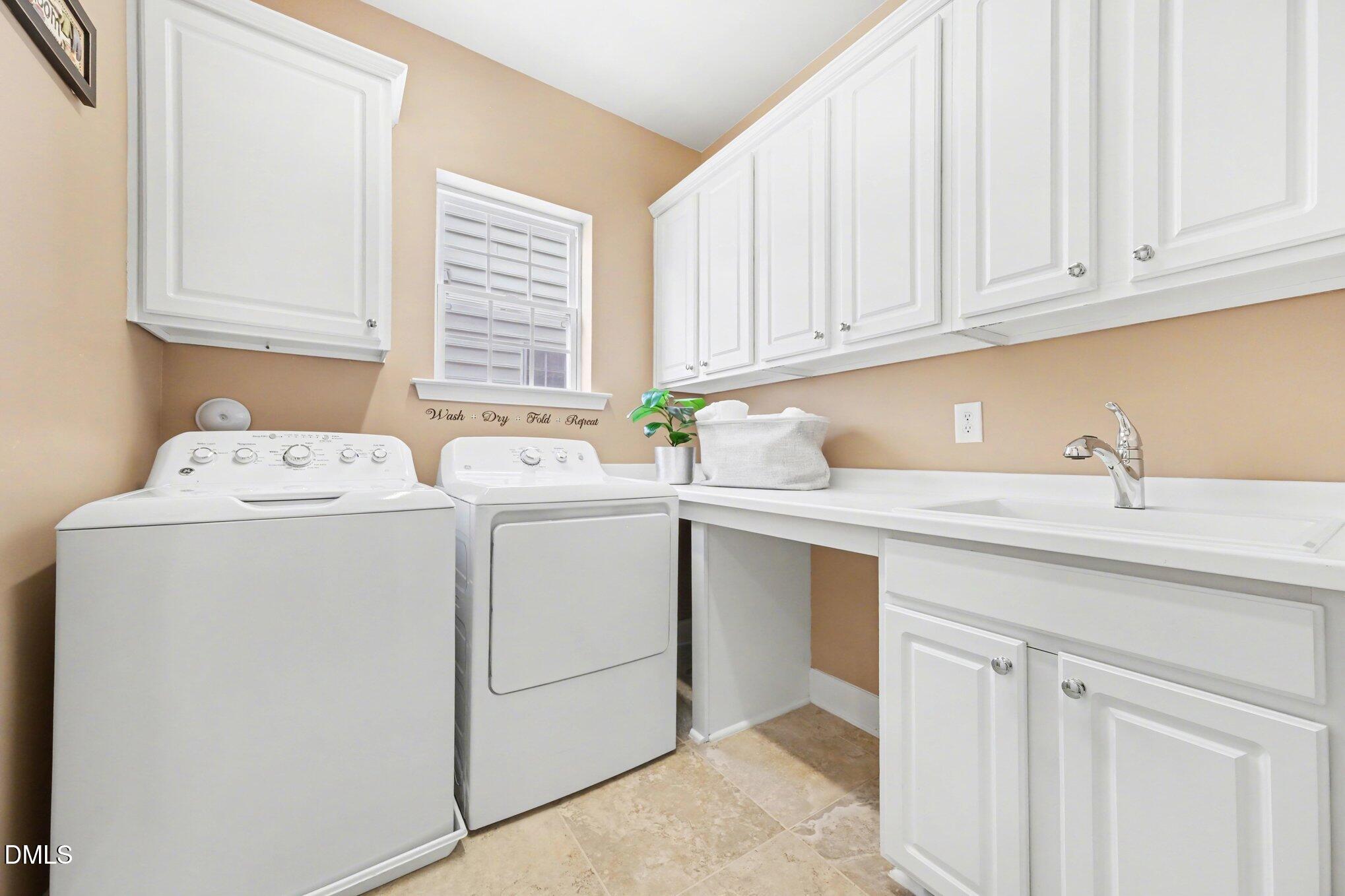 281 Beckingham Loop Cary, NC 27519 - Photo 27 of 56 a utility room with sink dryer and washer