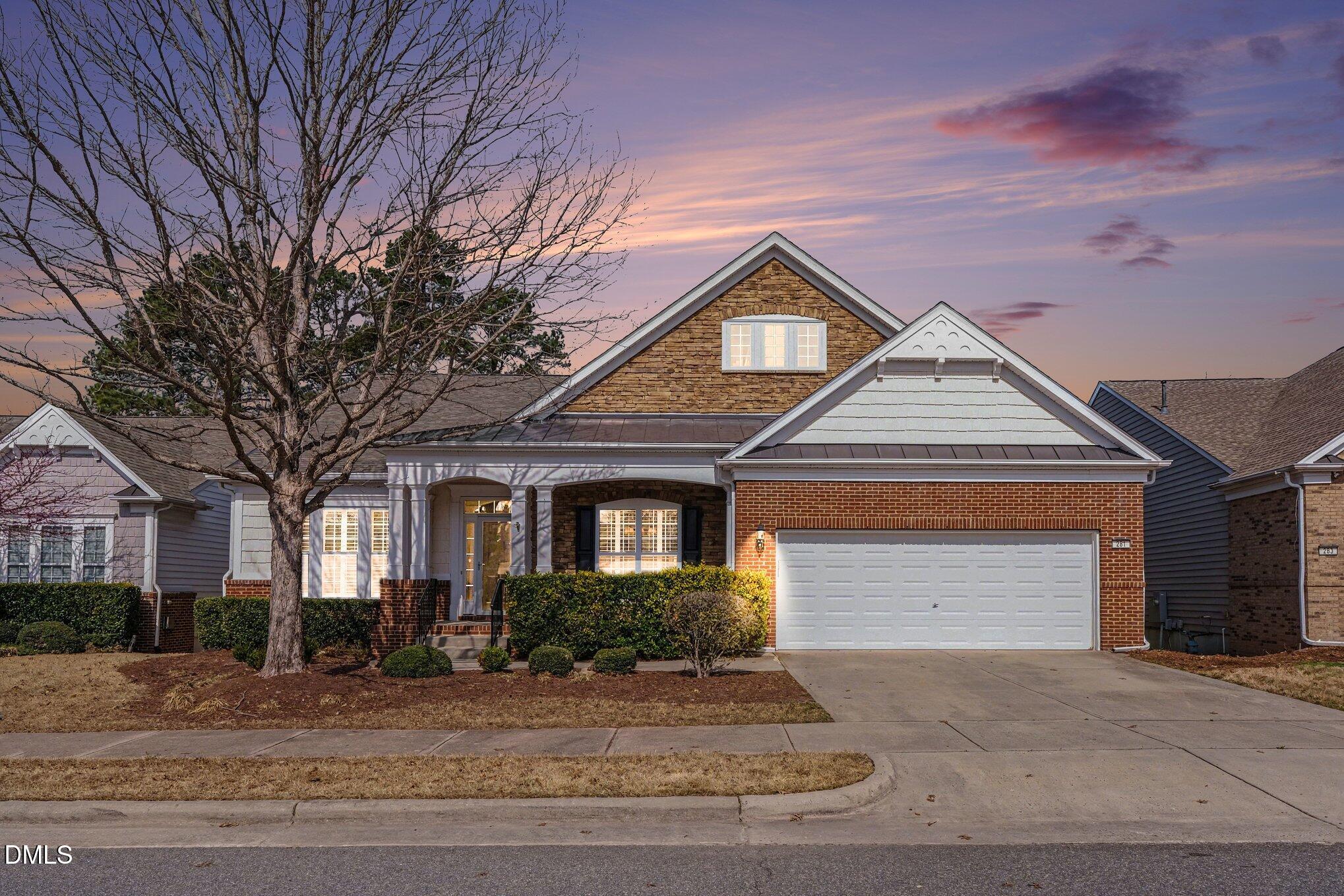 281 Beckingham Loop Cary, NC 27519 - Photo 2 of 56 a front view of a house with a yard and garage
