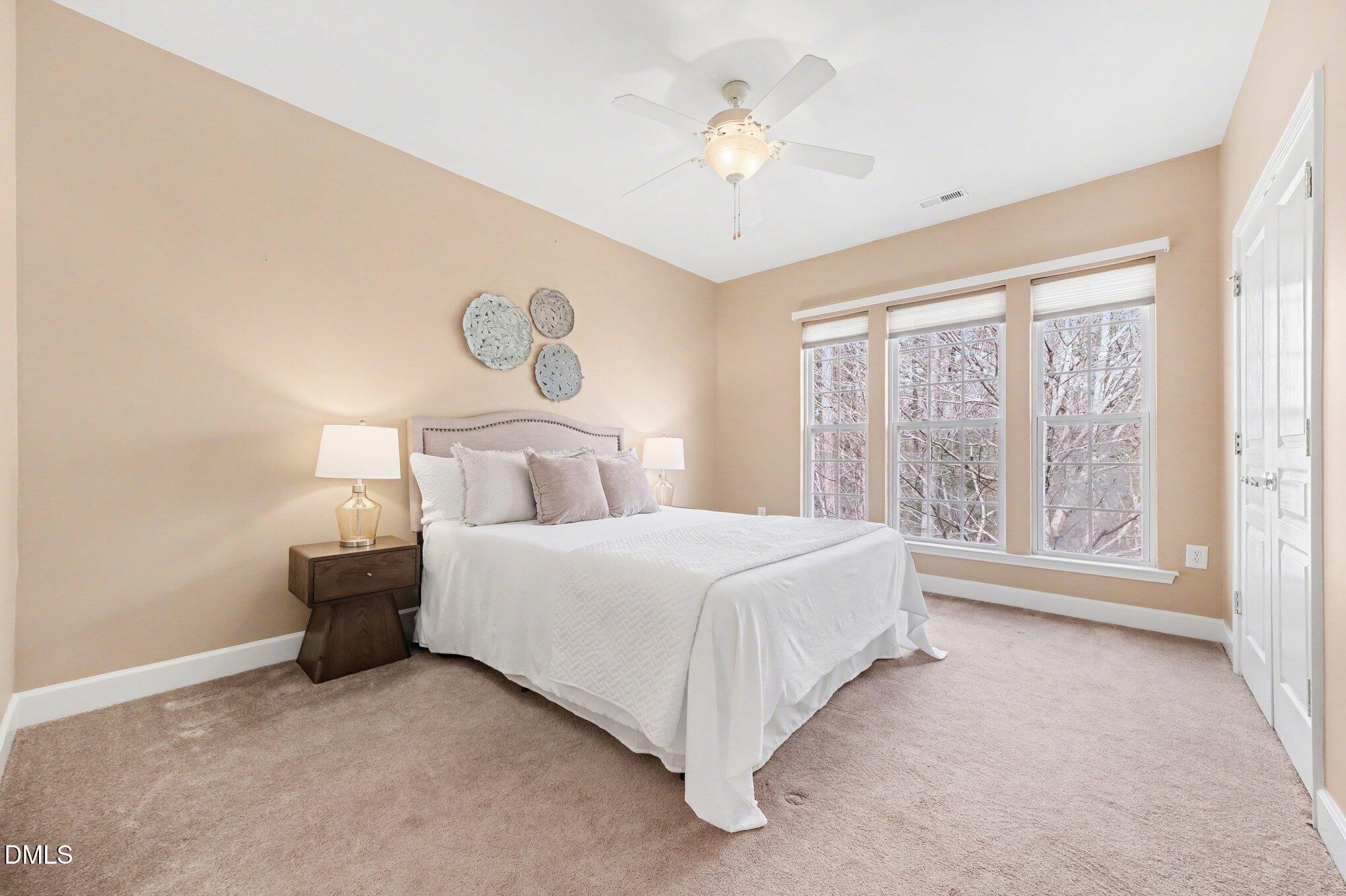 281 Beckingham Loop Cary, NC 27519 - Photo 28 of 56 a bedroom with a bed and a chandelier