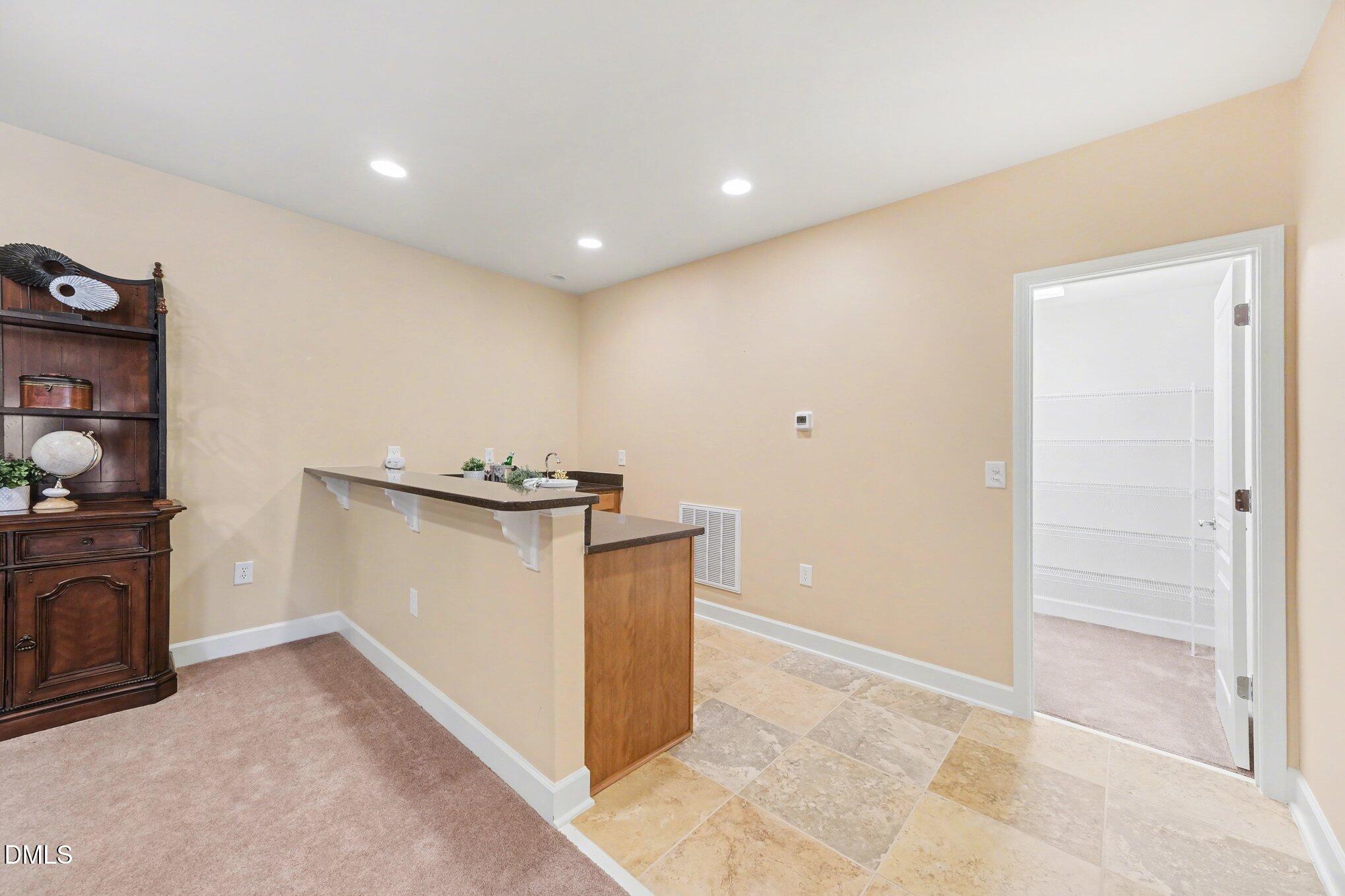 281 Beckingham Loop Cary, NC 27519 - Photo 34 of 56 a view of kitchen with cabinets and wooden floor