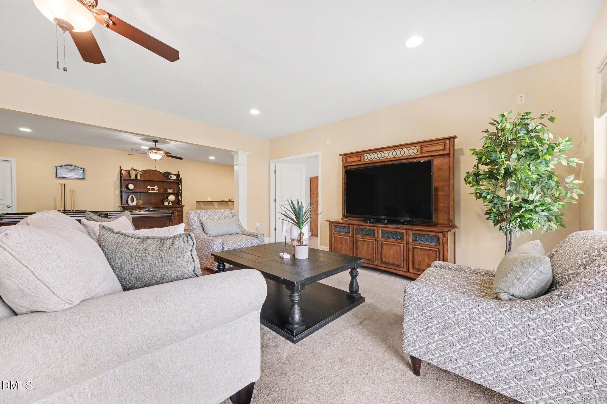 281 Beckingham Loop Cary, NC 27519 - Photo 37 of 56 a living room with furniture and a flat screen tv