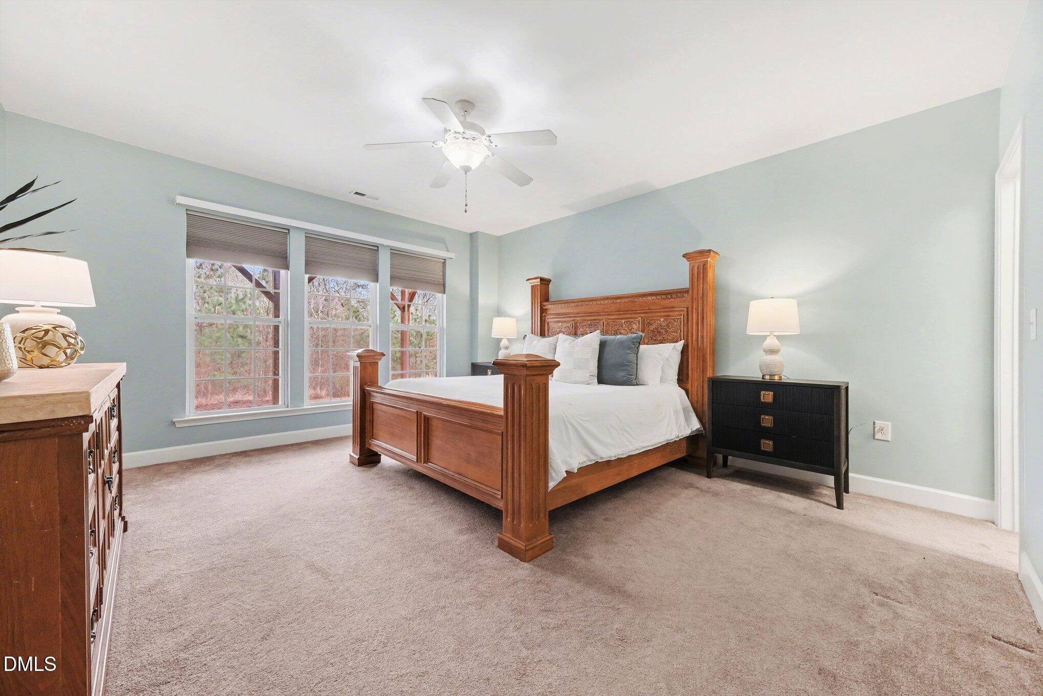 281 Beckingham Loop Cary, NC 27519 - Photo 39 of 56 a bedroom with a bed and a chandelier