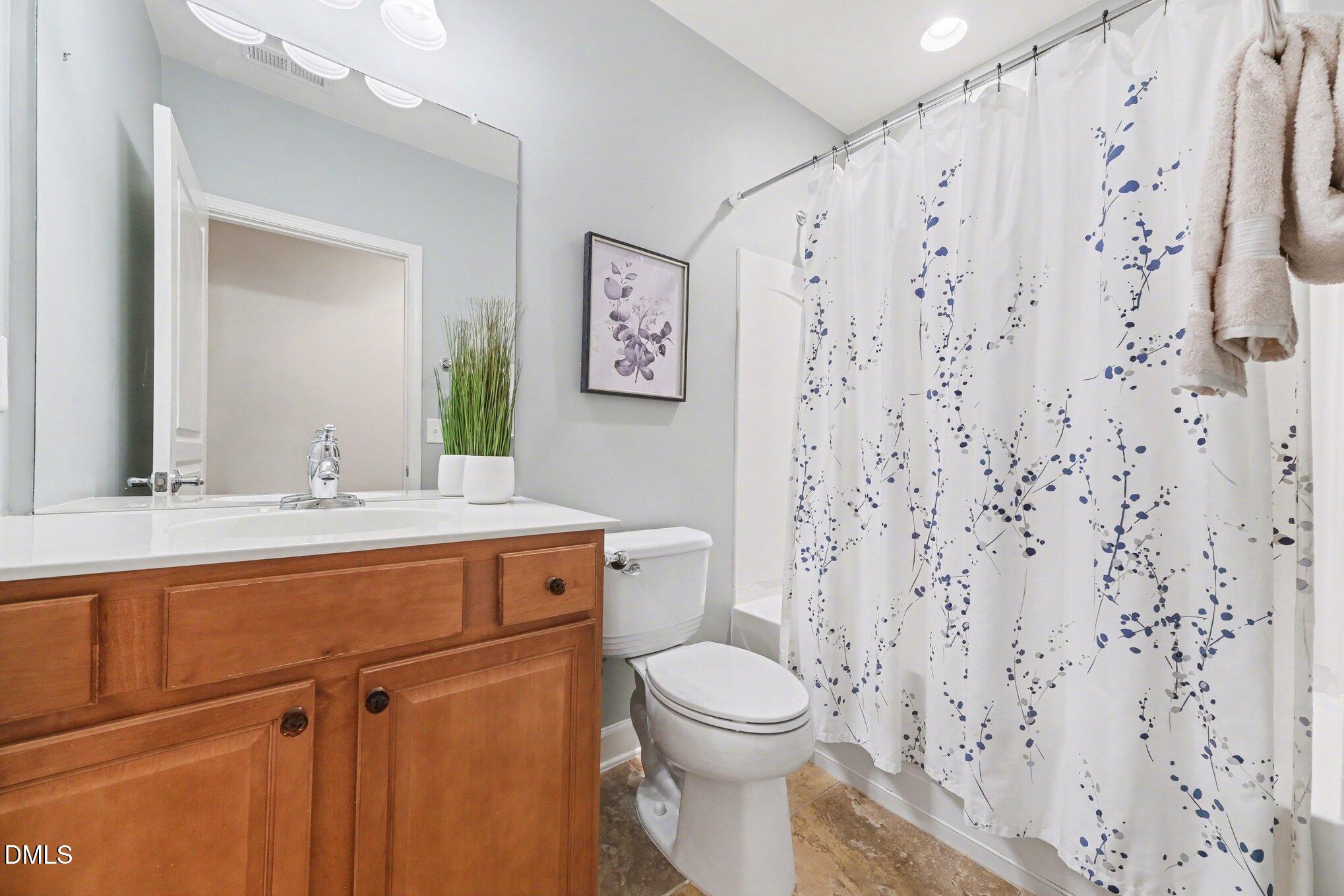 281 Beckingham Loop Cary, NC 27519 - Photo 40 of 56 a bathroom with a toilet sink and mirror