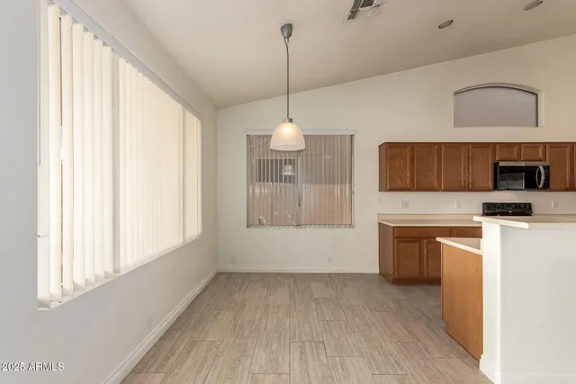 a view of a kitchen with a sink dishwasher and a fireplace