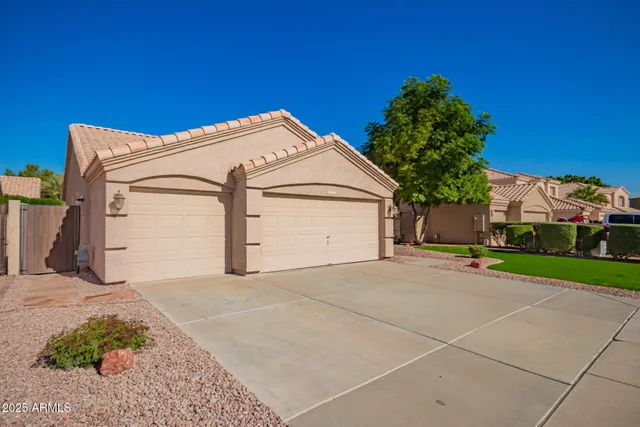 a view of a house with a yard and garage