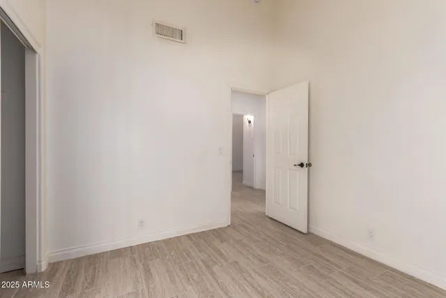a view of an empty room with wooden floor
