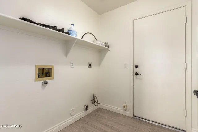 a room with a walk in closet and wooden floor