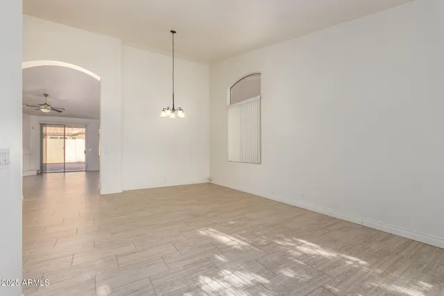 en empty room with window and wooden floor