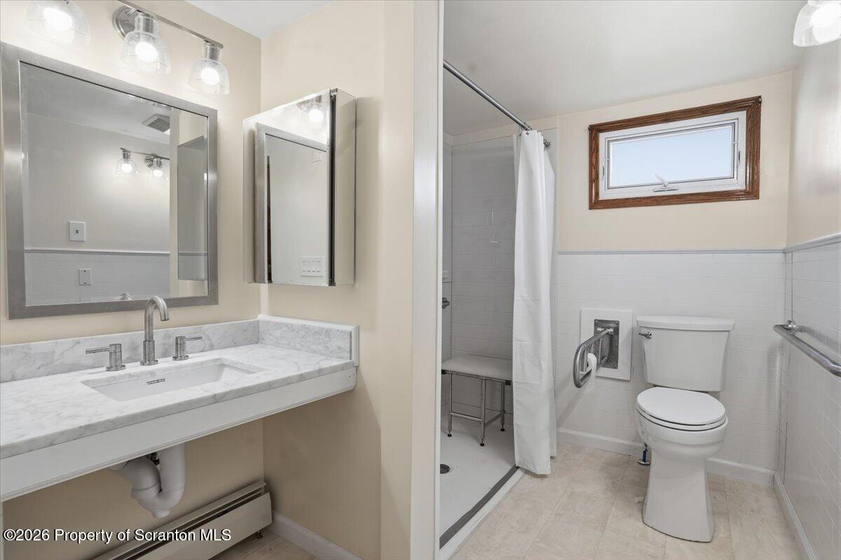 101 Stone Street Moosic, PA 18507 - Photo 16 of 53 a bathroom with a toilet sink and mirror