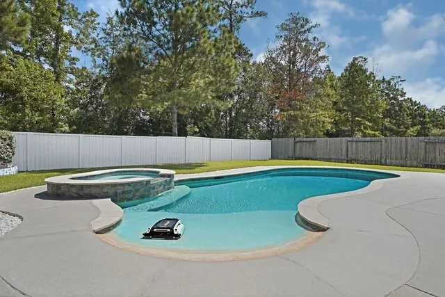 a view of a swimming pool and a yard