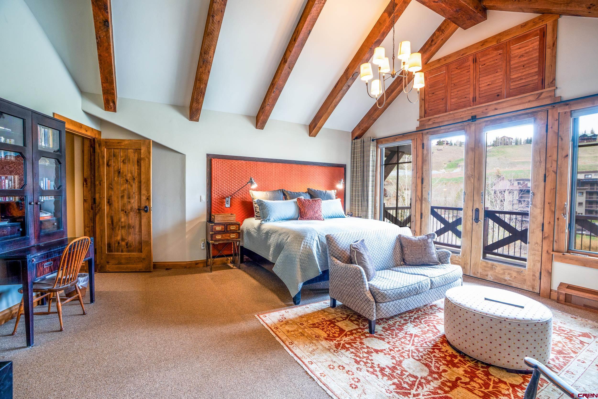 14 Hunter Hill Road, Unit A405 Crested Butte, CO 81225 - Photo 13 of 38 a bed room with a bed and a couch