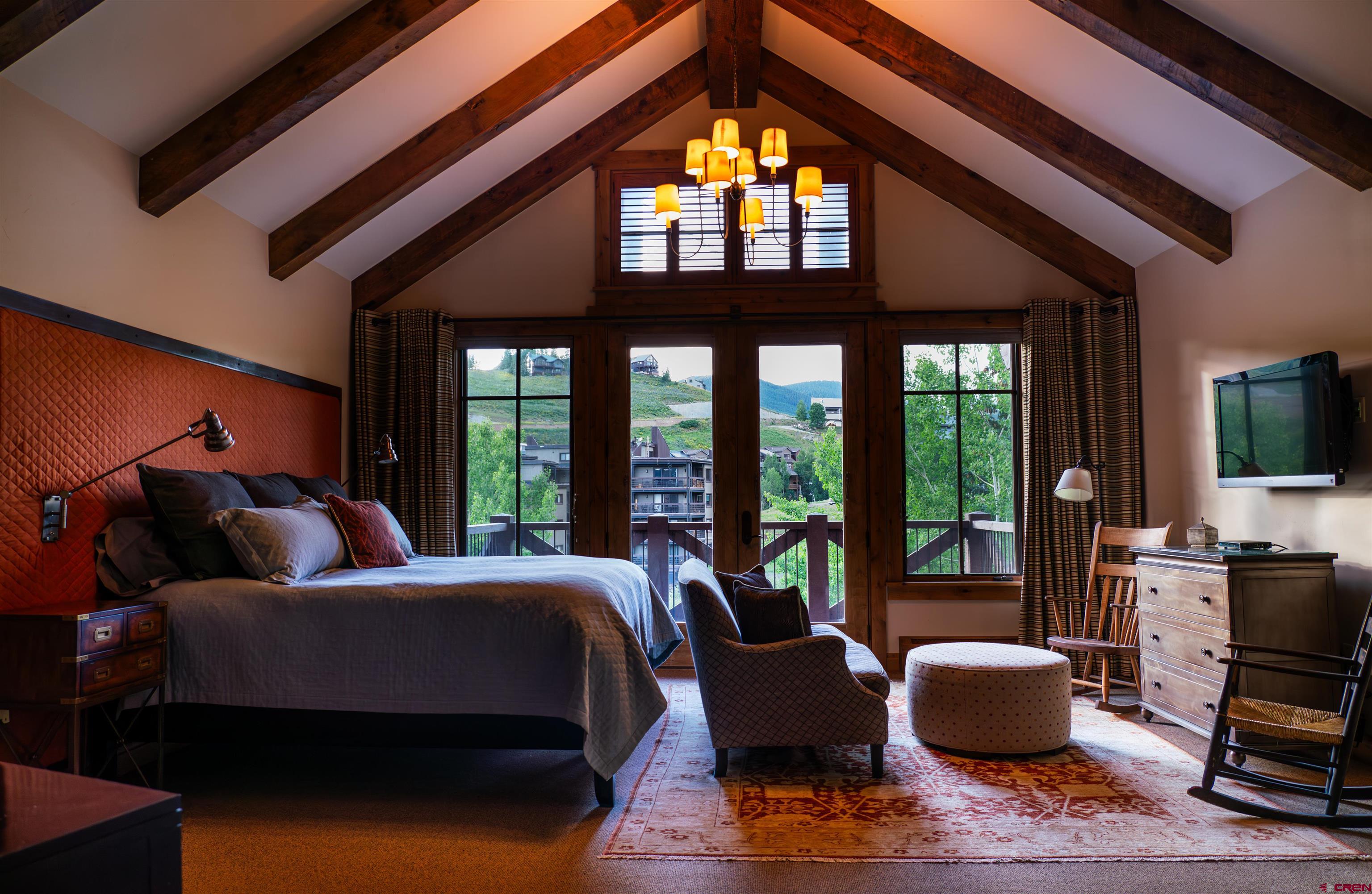 14 Hunter Hill Road, Unit A405 Crested Butte, CO 81225 - Photo 14 of 38 a bedroom with furniture and a flat screen tv