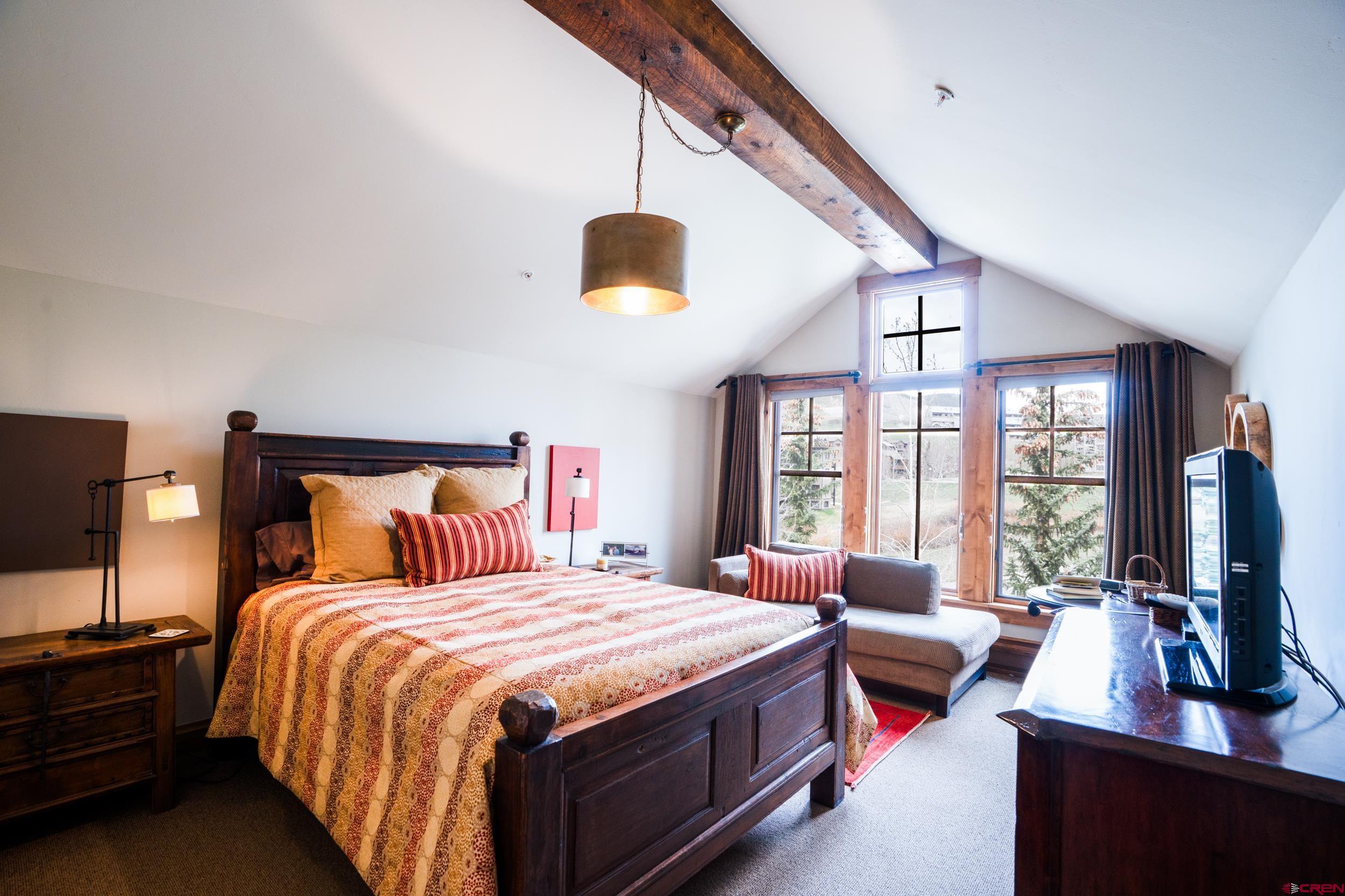 14 Hunter Hill Road, Unit A405 Crested Butte, CO 81225 - Photo 19 of 38 a bedroom with bed and flat screen tv