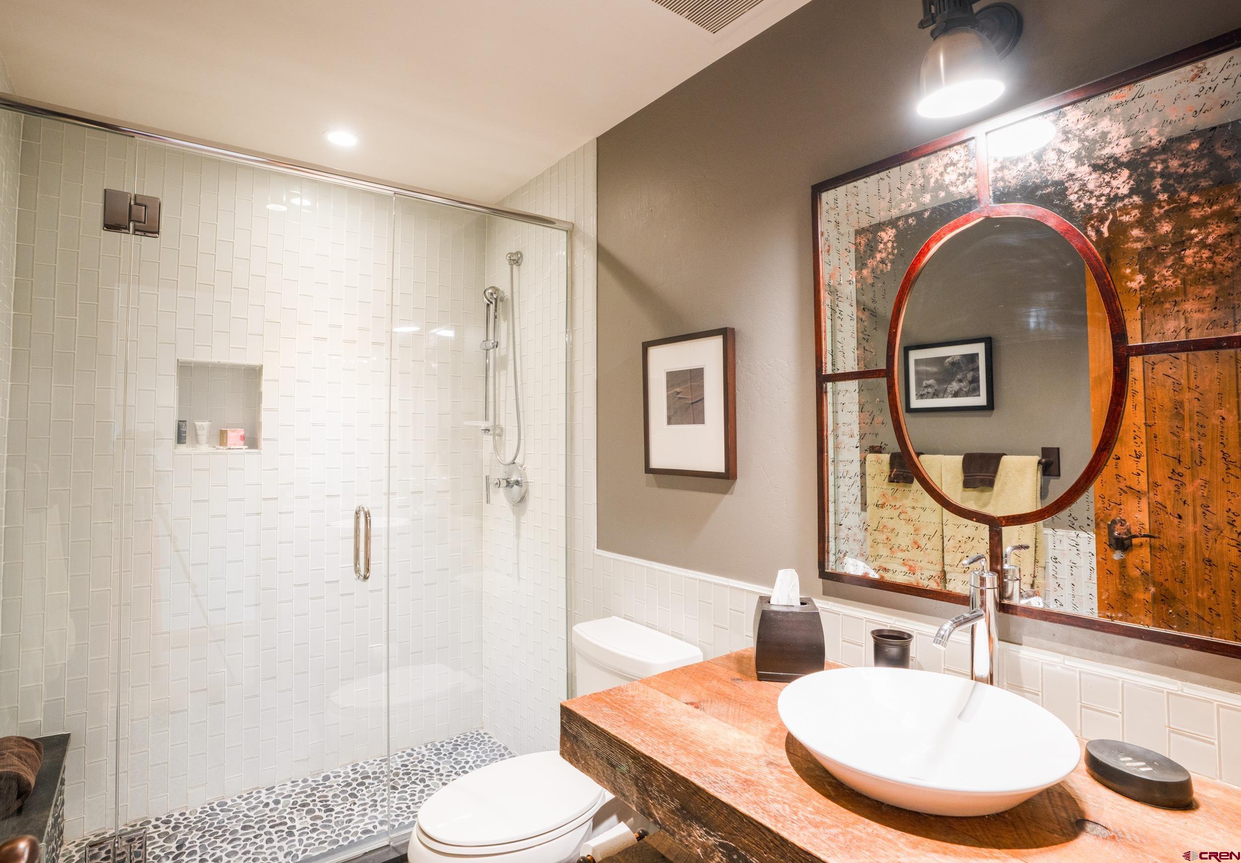 14 Hunter Hill Road, Unit A405 Crested Butte, CO 81225 - Photo 20 of 38 a bathroom with a toilet a sink and a mirror