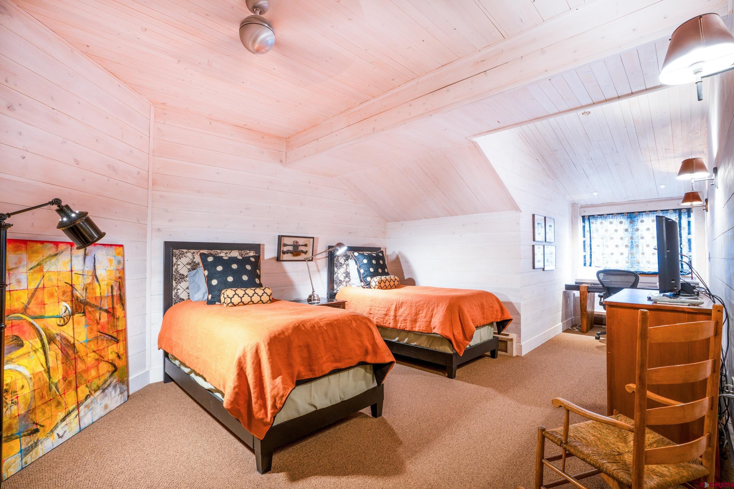 14 Hunter Hill Road, Unit A405 Crested Butte, CO 81225 - Photo 21 of 38 a bedroom with two beds and painting on the wall