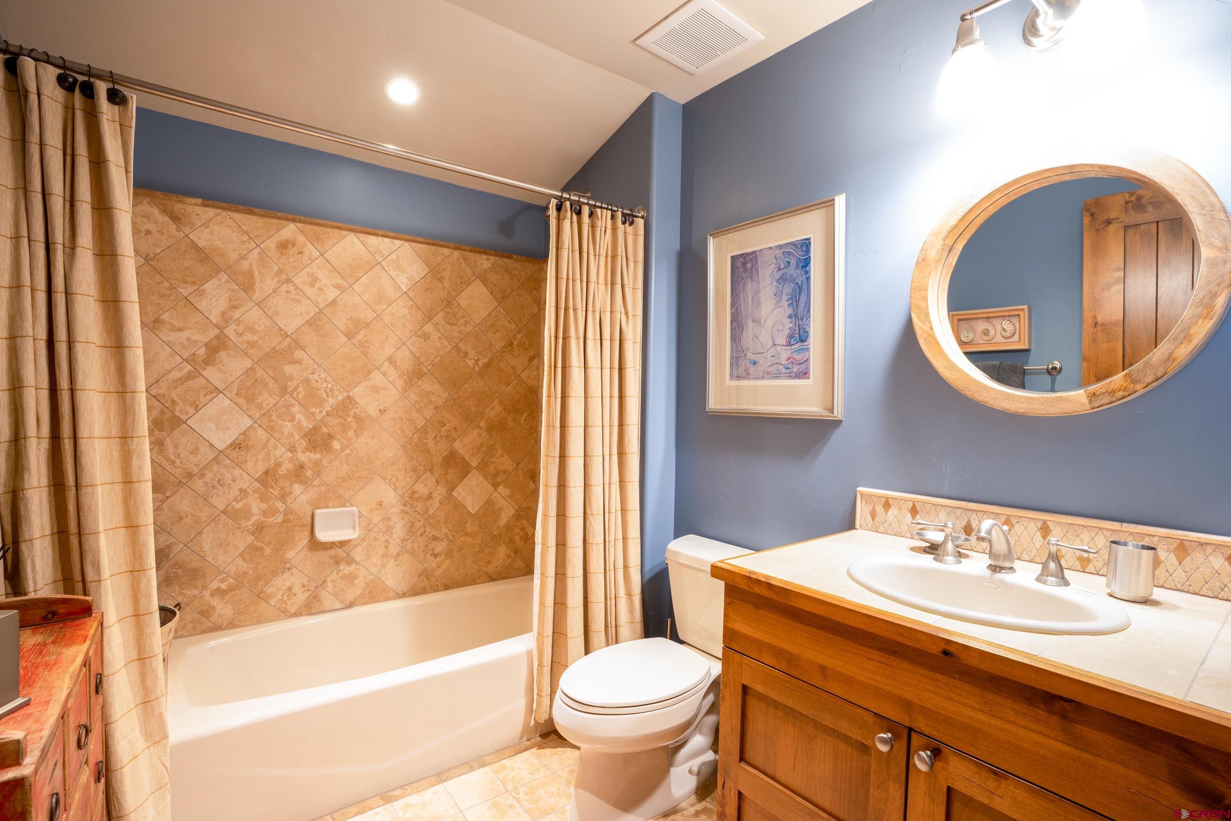 14 Hunter Hill Road, Unit A405 Crested Butte, CO 81225 - Photo 22 of 38 a bathroom with a toilet a sink and a mirror
