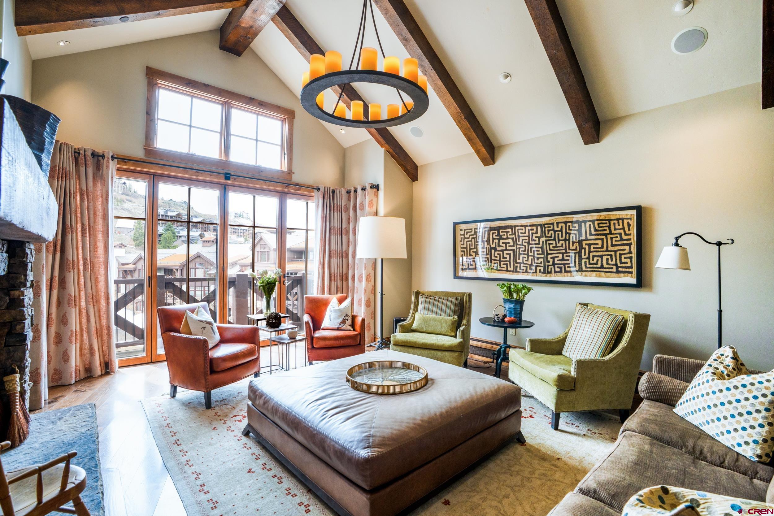 14 Hunter Hill Road, Unit A405 Crested Butte, CO 81225 - Photo 4 of 38 a living room with furniture and a floor to ceiling window