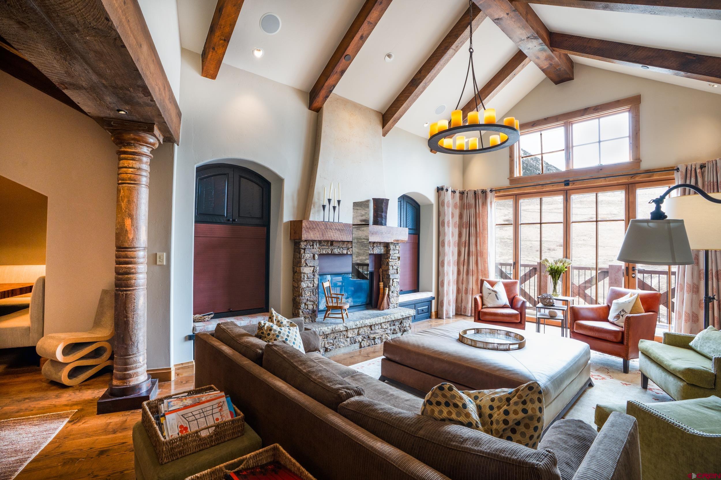 14 Hunter Hill Road, Unit A405 Crested Butte, CO 81225 - Photo 6 of 38 a living room with fireplace furniture and a chandelier