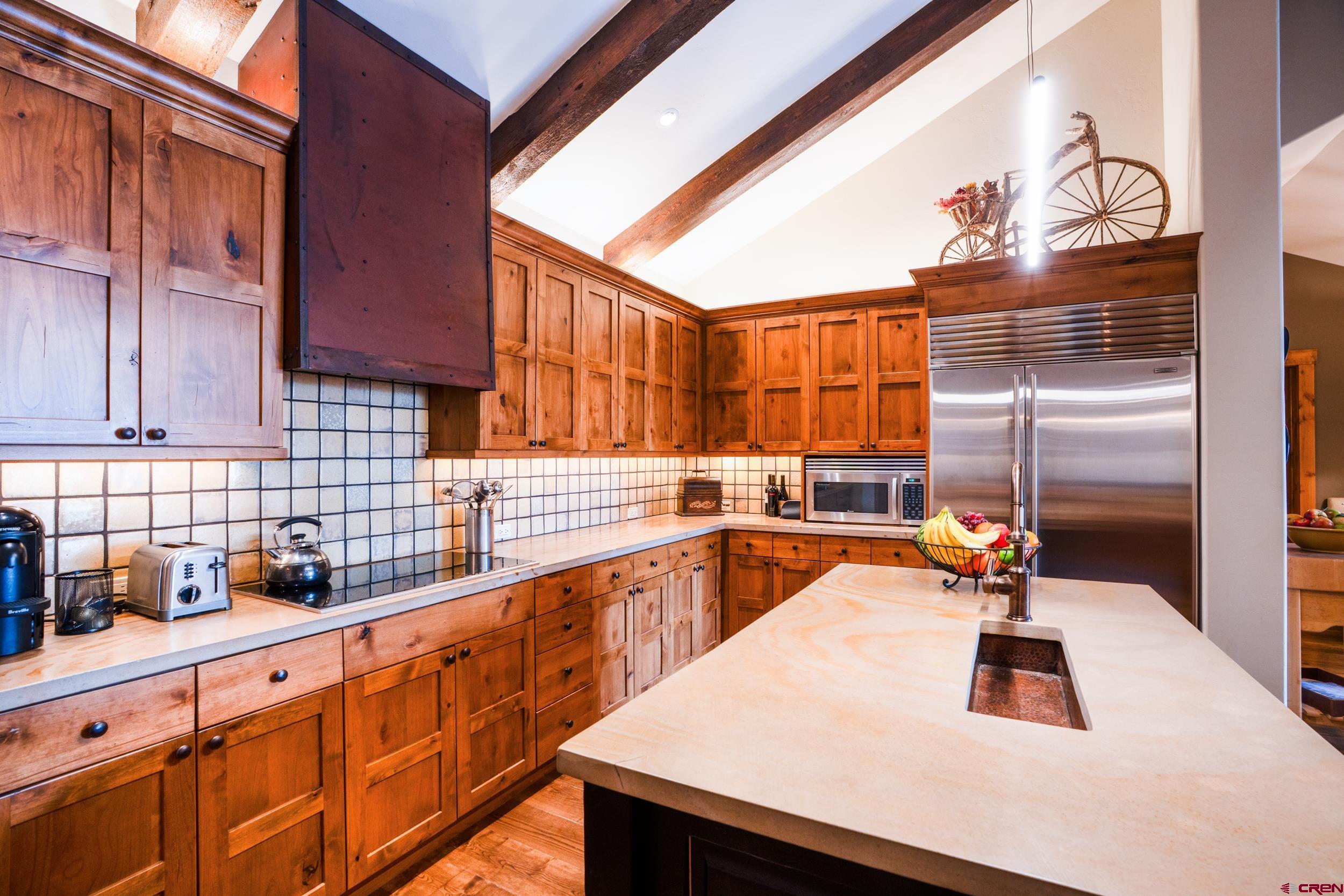 14 Hunter Hill Road, Unit A405 Crested Butte, CO 81225 - Photo 10 of 38 a kitchen with stainless steel appliances a sink a counter space and cabinets