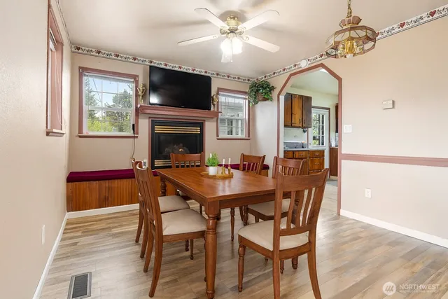 a dining room with furniture a chandelier and wooden floor