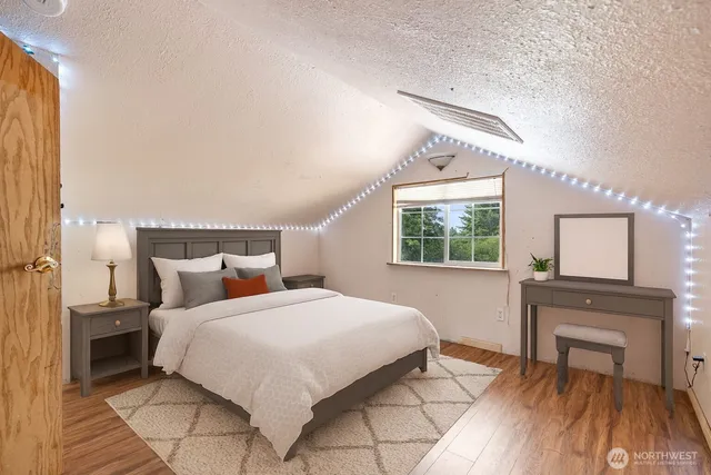 a bedroom with a bed and a window