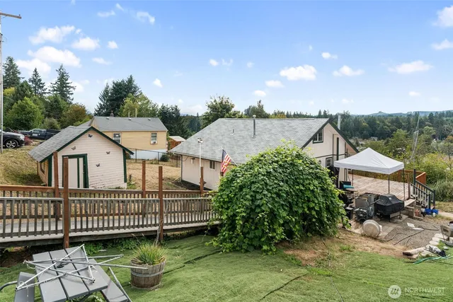 a view of a house with a balcony and wooden deck