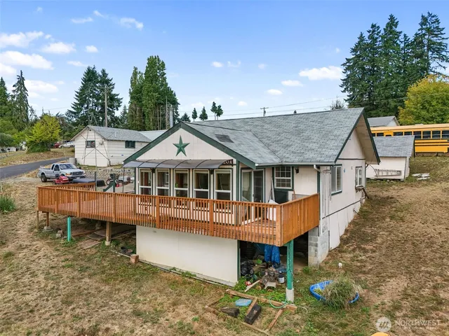 an aerial view of a house with a yard balcony and sitting area