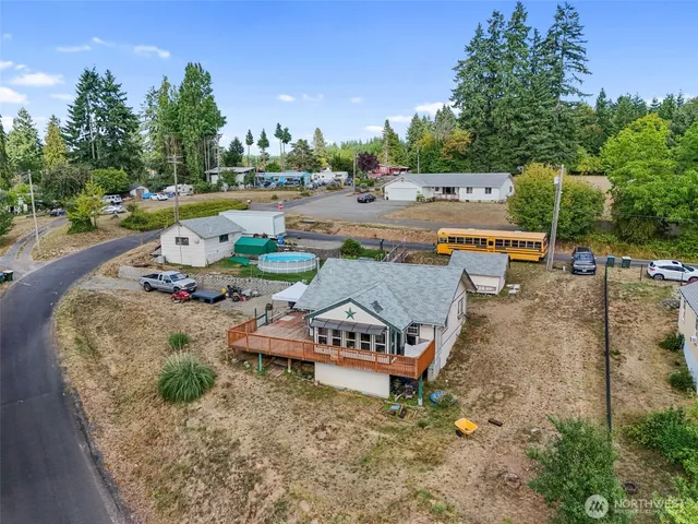 an aerial view of a house with garden space and street view