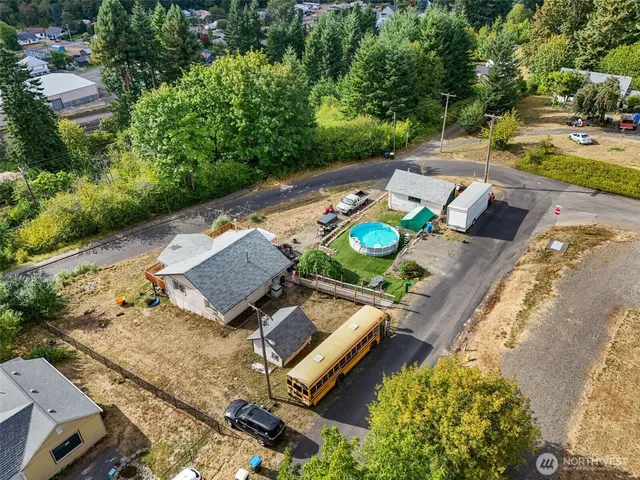 an aerial view of a backyard with chairs