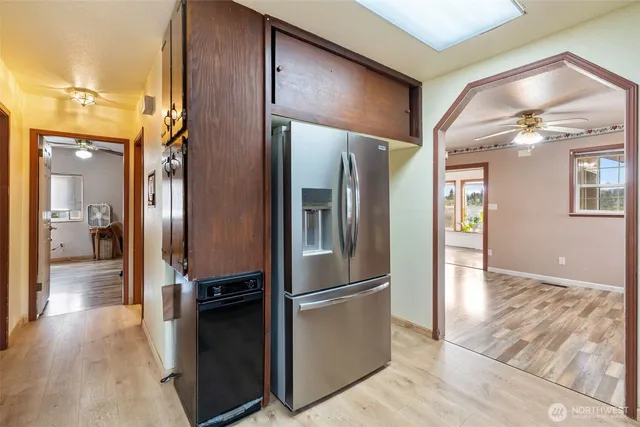 a view of a refrigerator in kitchen and an entryway
