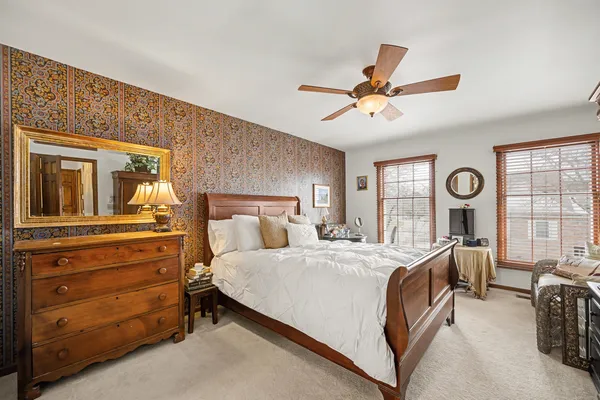 a bedroom with a bed dresser and a window