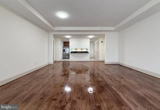 a view of a room with wooden floor