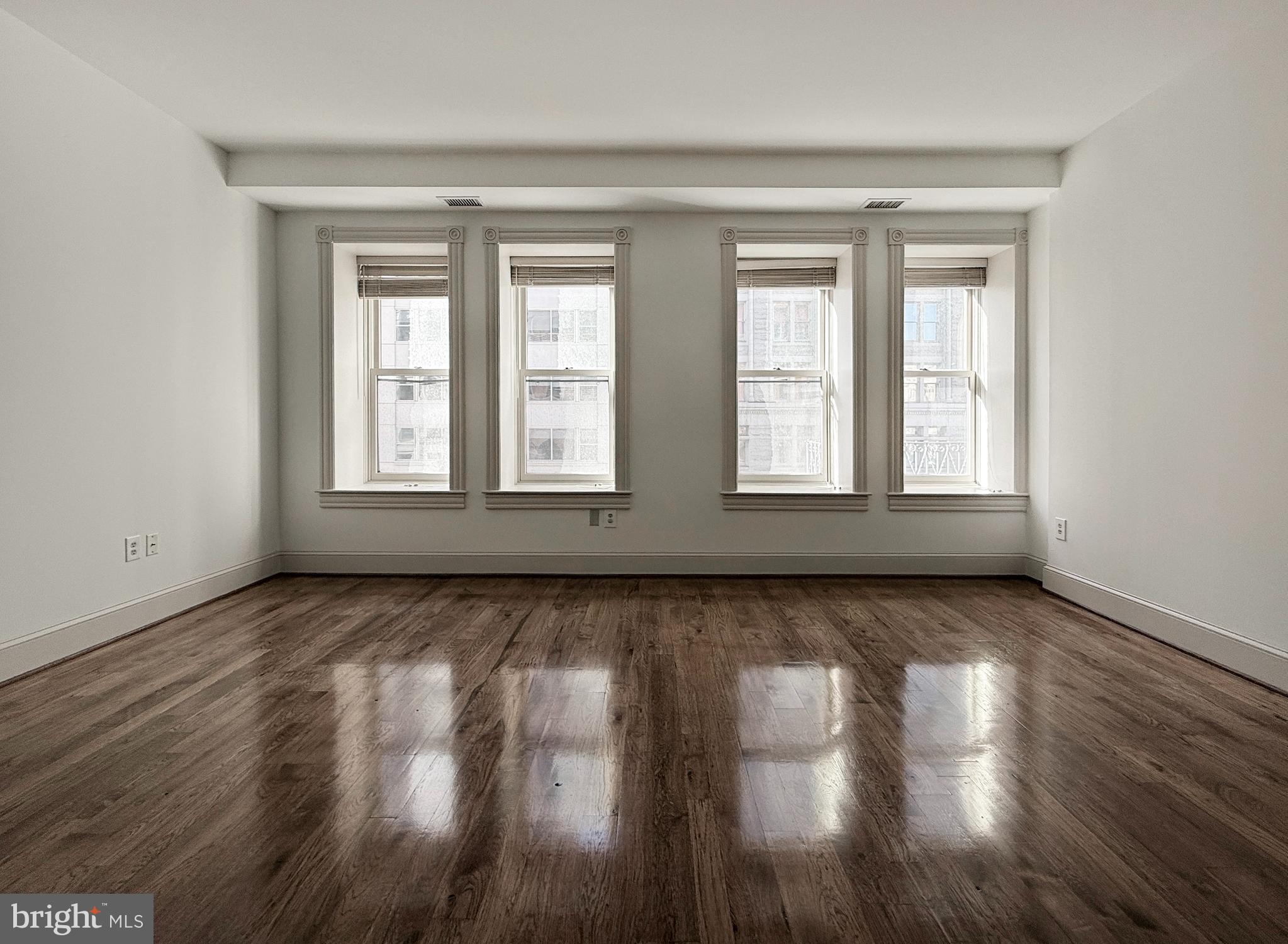 515 9th Street Northwest, Unit 3E Washington, DC 20004 - Photo 15 of 20 a view of an empty room with wooden floor and window