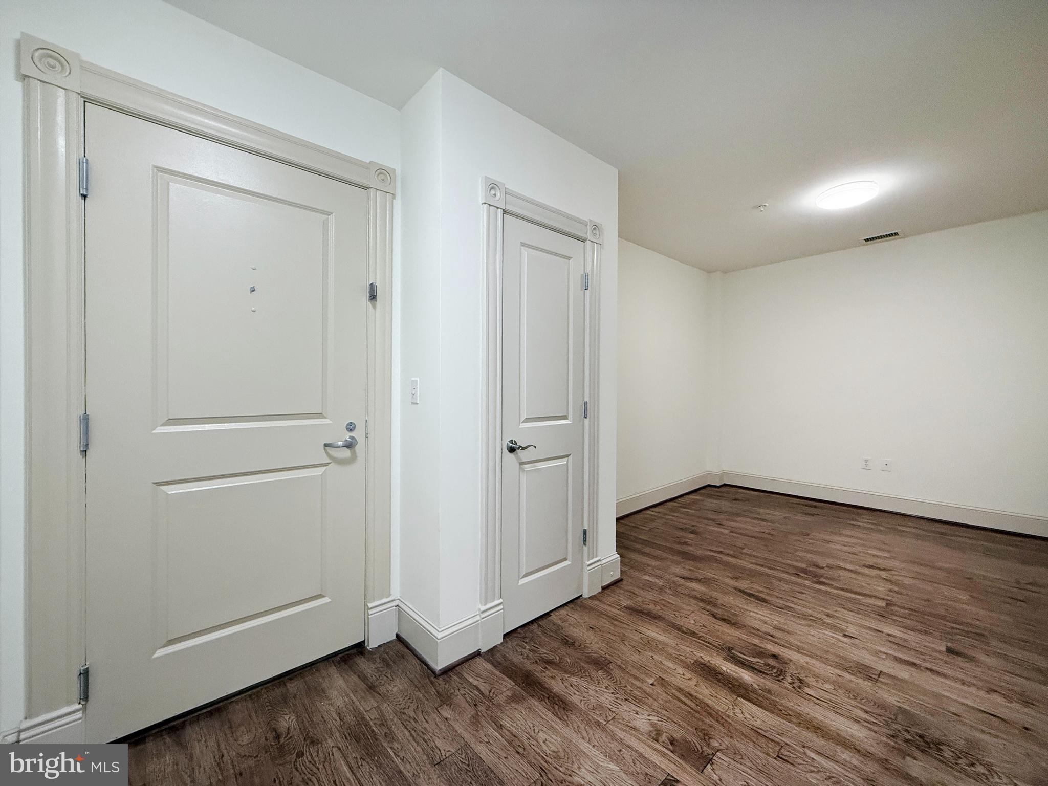 515 9th Street Northwest, Unit 3E Washington, DC 20004 - Photo 4 of 20 an empty room with wooden floor