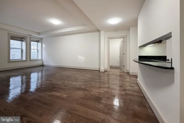 a view of a kitchen with a sink and a refrigerator