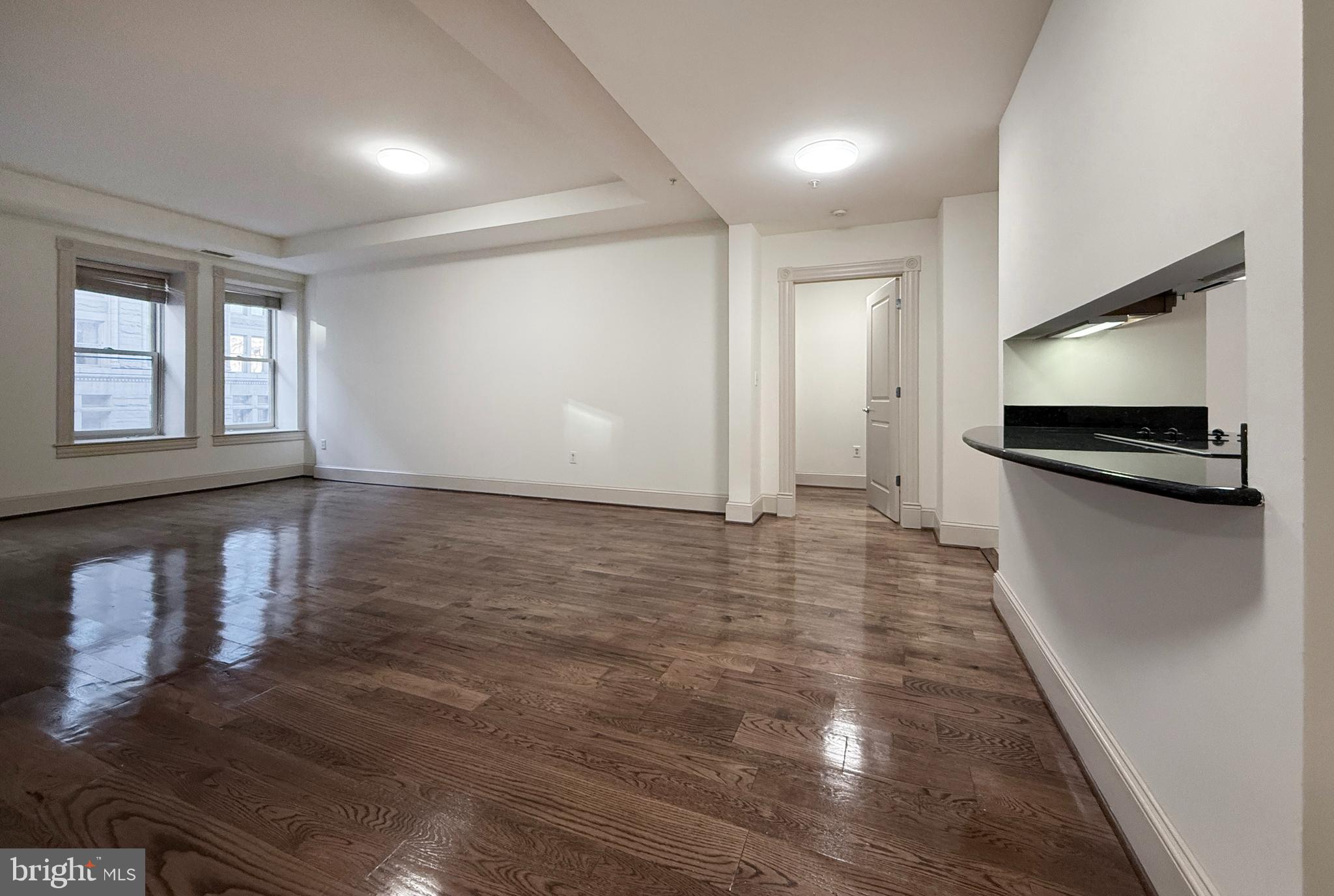 515 9th Street Northwest, Unit 3E Washington, DC 20004 - Photo 10 of 20 a view of a kitchen with a sink and a refrigerator