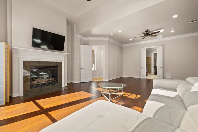 a living room with furniture a fireplace and a flat screen tv