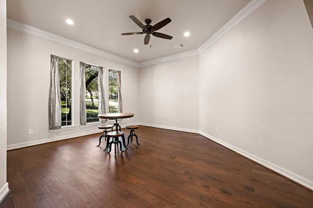 a view of a workspace with furniture window and wooden floor