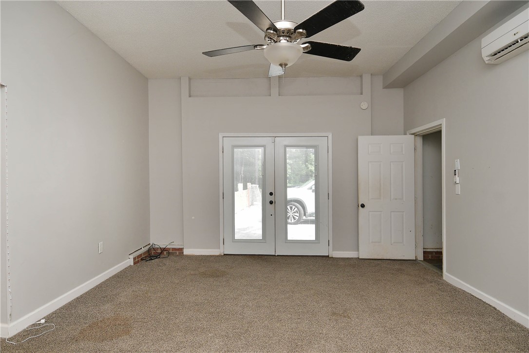 197 Deer Creek Road Easley, SC 29640 - Photo 34 of 50 An inviting room features a ceiling fan, plush carpet, and glass French doors leading to the outdoors.