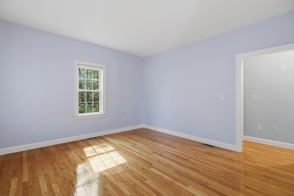 61 Indian Head Road Framingham, MA 01701 - Photo 19 of 42 a view of an empty room with wooden floor and a window