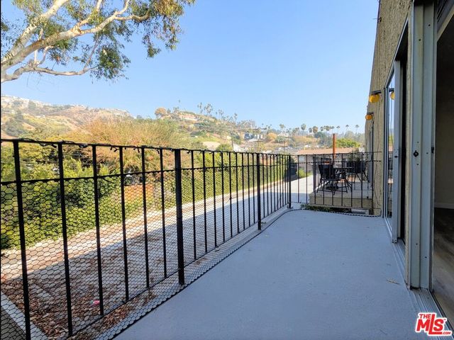 a view of a balcony with furniture