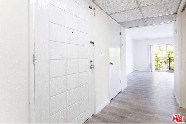 a view of hallway with wooden floor