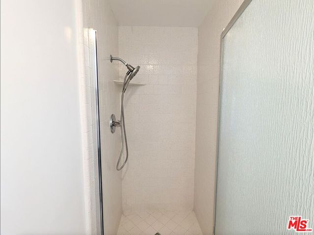 a bathroom with a glass shower door