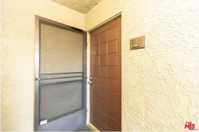 a front view of a building with a garden