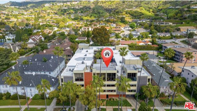 a front view of a building with a garden